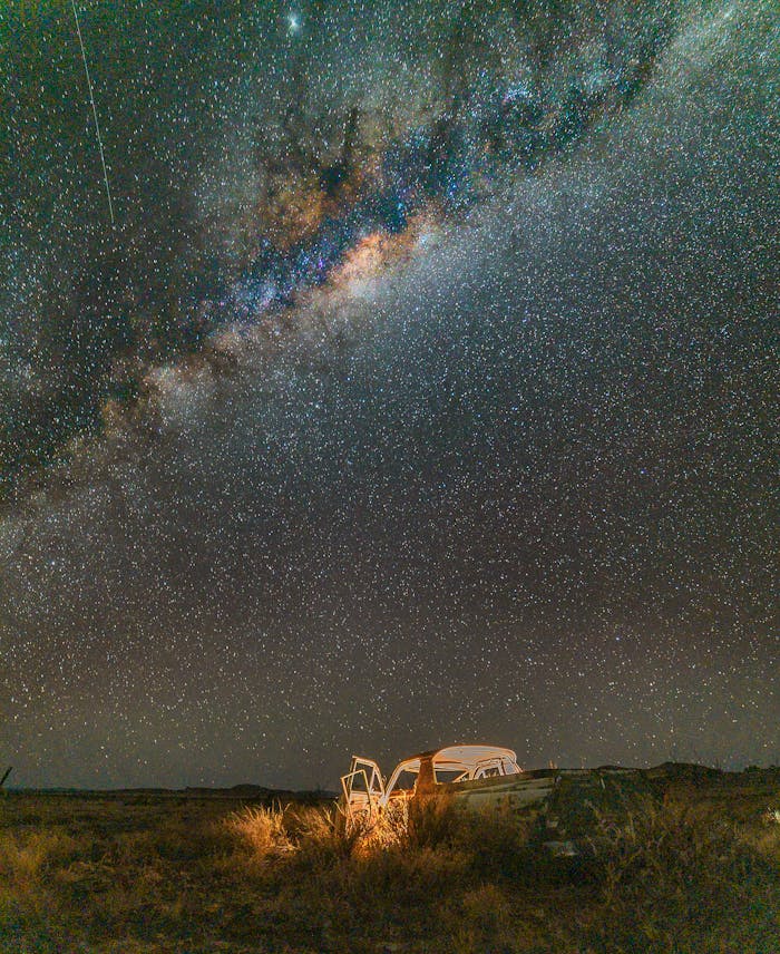 A breathtaking view of the Milky Way galaxy over a rural landscape in Western Australia, showcasing a starry night sky.